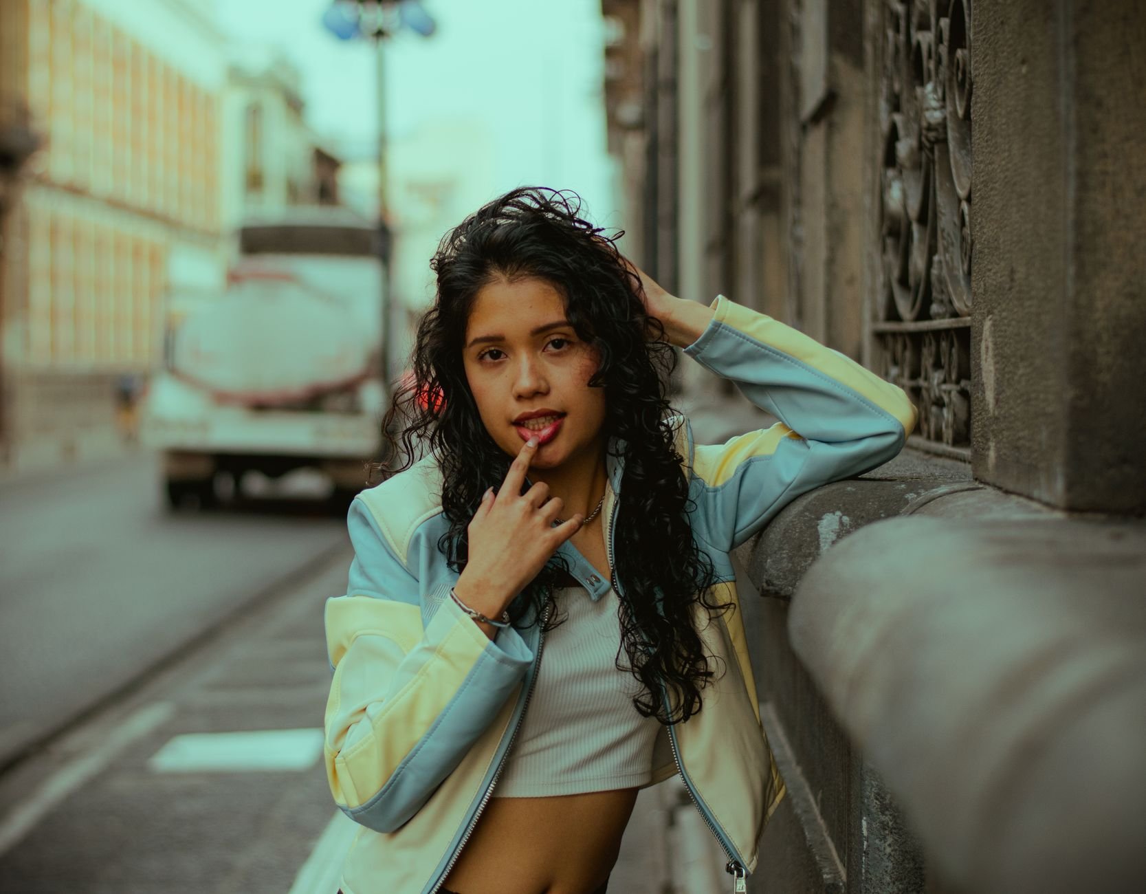 Young woman posing confidently on a city street.